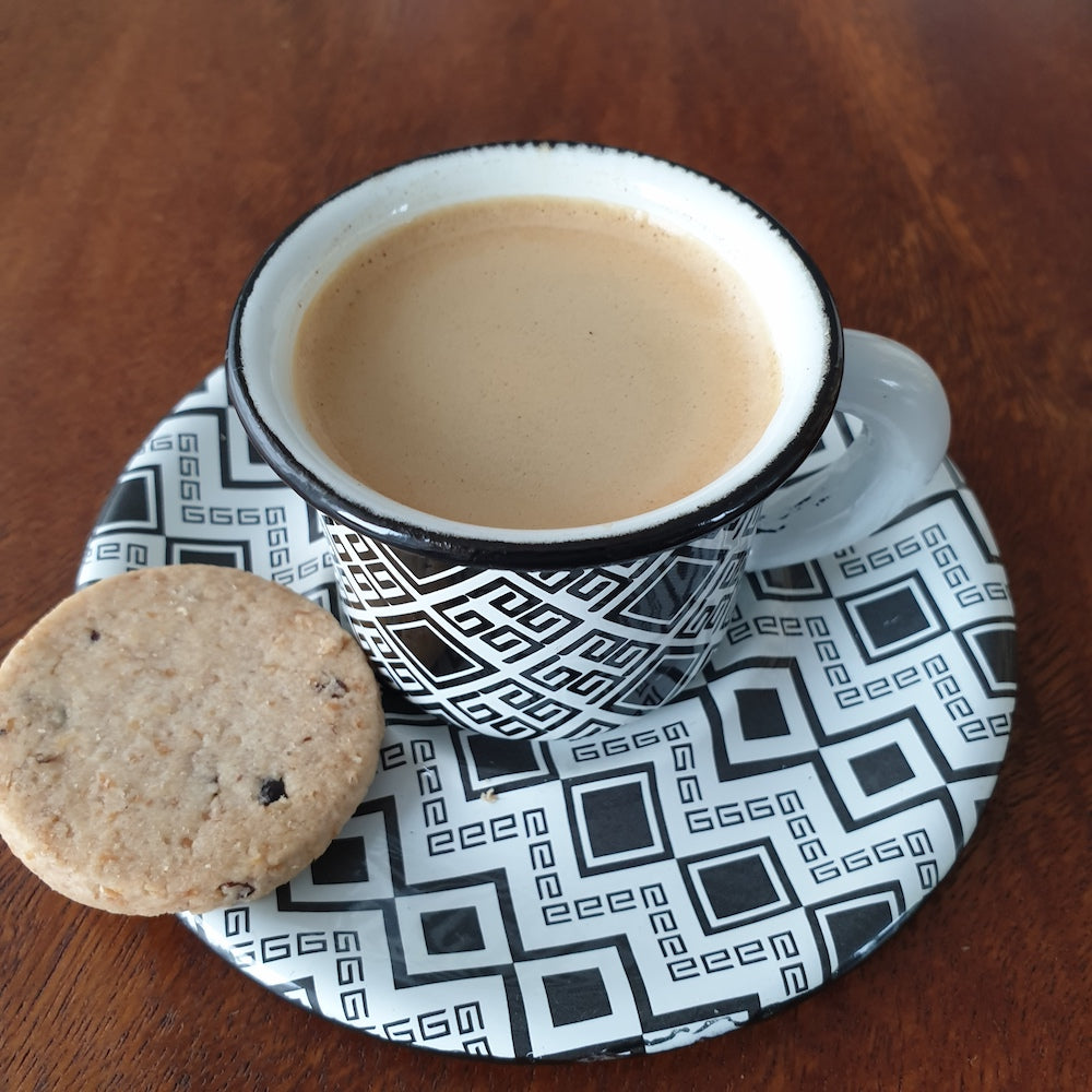 Enamel espresso cup with plate set, warm coffee and cookie