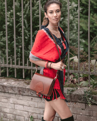 Confident woman going out wearing Taabal Rebozo Coral Shawl Wrap by 32 Estados