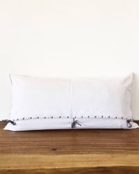 Eustaquia Luna Throw Pillow back view with ribbons