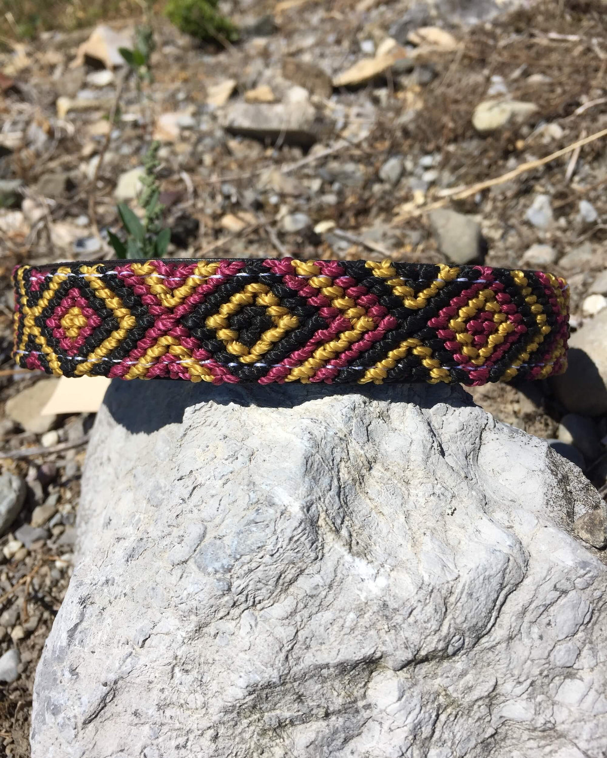 Makan Medium Size Dog Collar Black, Gold & Wine on top of rock