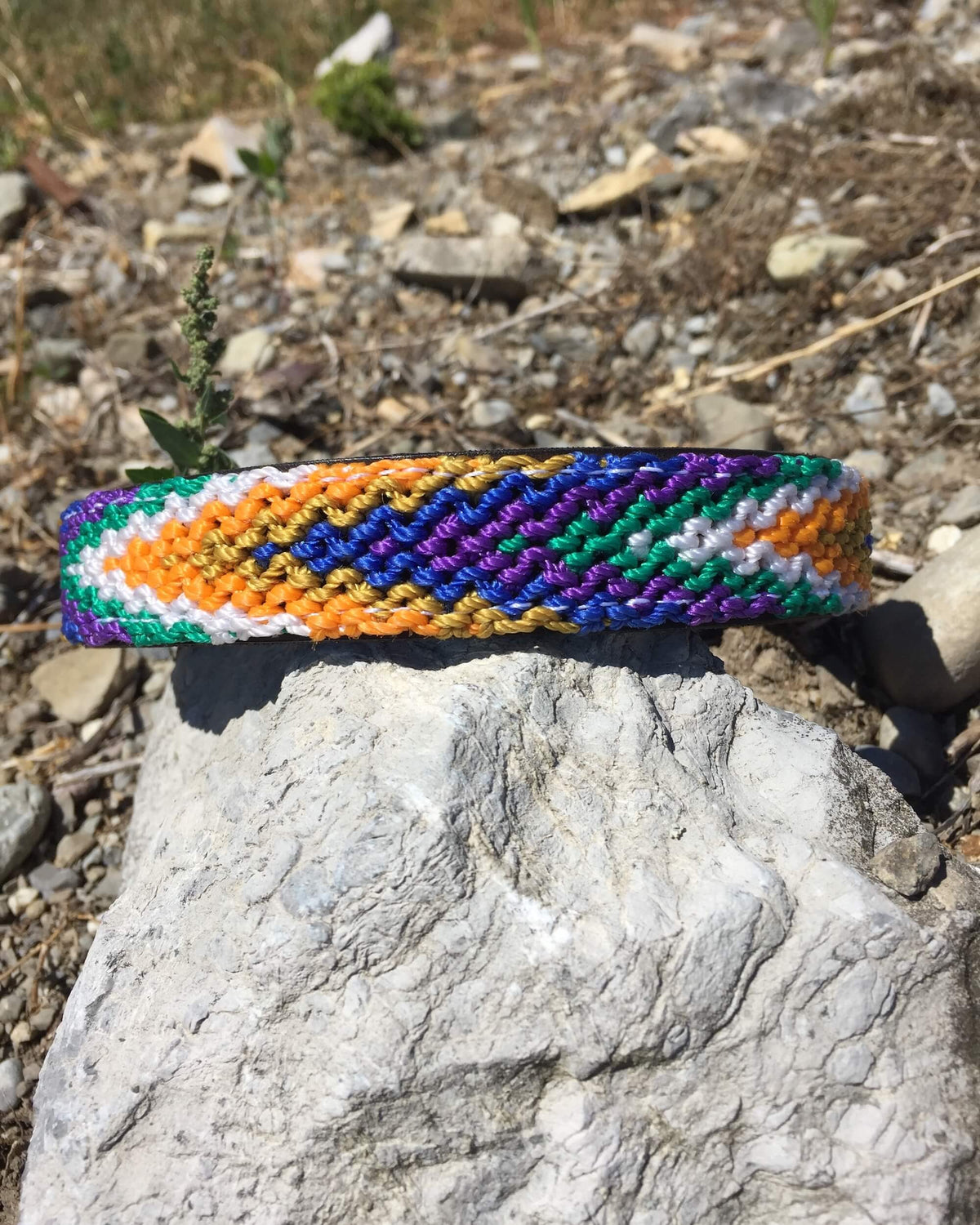 Makan Medium Size Dog Collar Purple, Blue & Orange on top of rock