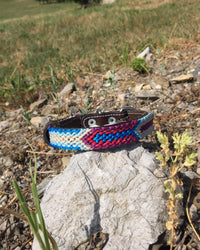 Makan Small Size Dog Collar Blue, White & Purple on top of rock