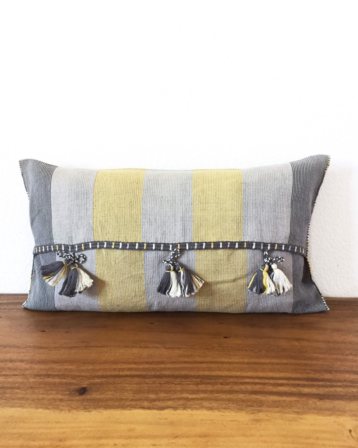 Universo Lalo Throw Pillow grey tones and a touch of yellow back view of ribbons