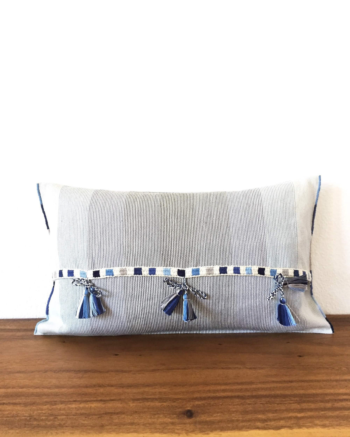 Universo Pulmo Throw Pillow light blue and grey tones with brocades in pastel colors back view of ribbons