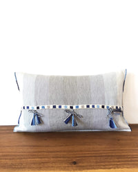 Universo Pulmo Throw Pillow light blue and grey tones with brocades in pastel colors back view of ribbons