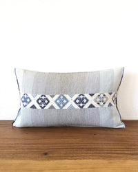 Universo Pulmo Throw Pillow light blue and grey tones with brocades in pastel colors front view